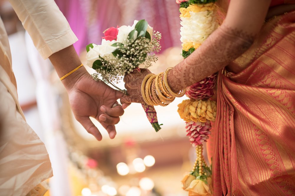 Indian wedding holding hands