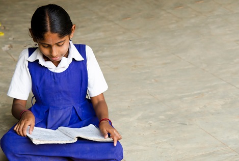 beautiful girl writing in a village school
