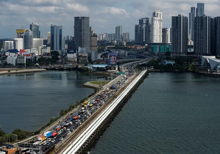 Commuters take the Woodlands Causeway to Singapore from Johor a day before Malaysia imposes a lockdown on travel due to the coronavirus outbreak in Singapore March 17, 2020.  REUTERS/Edgar Su