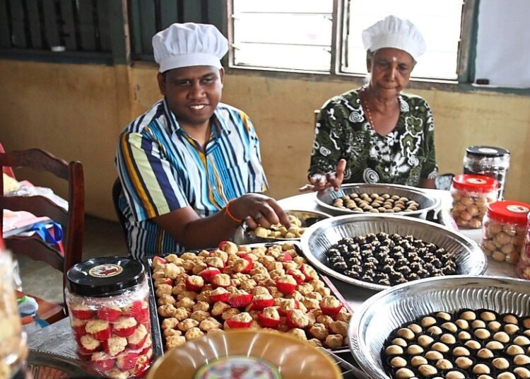 (seated left to right) Ruben and Kanamal busy preparing the different types of cookies their customers had ordered for Deepavali at thier home in Kampung Baru Sungai Lalang in Sungai Petani,Kedah. ( November 4,2020 ). — ZHAFARAN NASIB/The Star