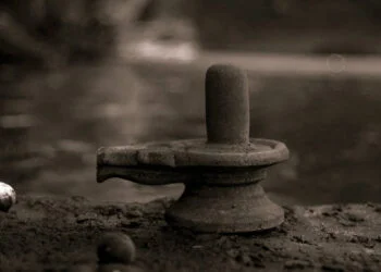 An old shiva linga on a river bank