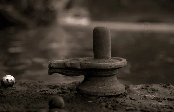 An old shiva linga on a river bank