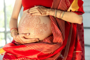 pregnant woman belly henna tattoo indian picture hands white room background 57904251