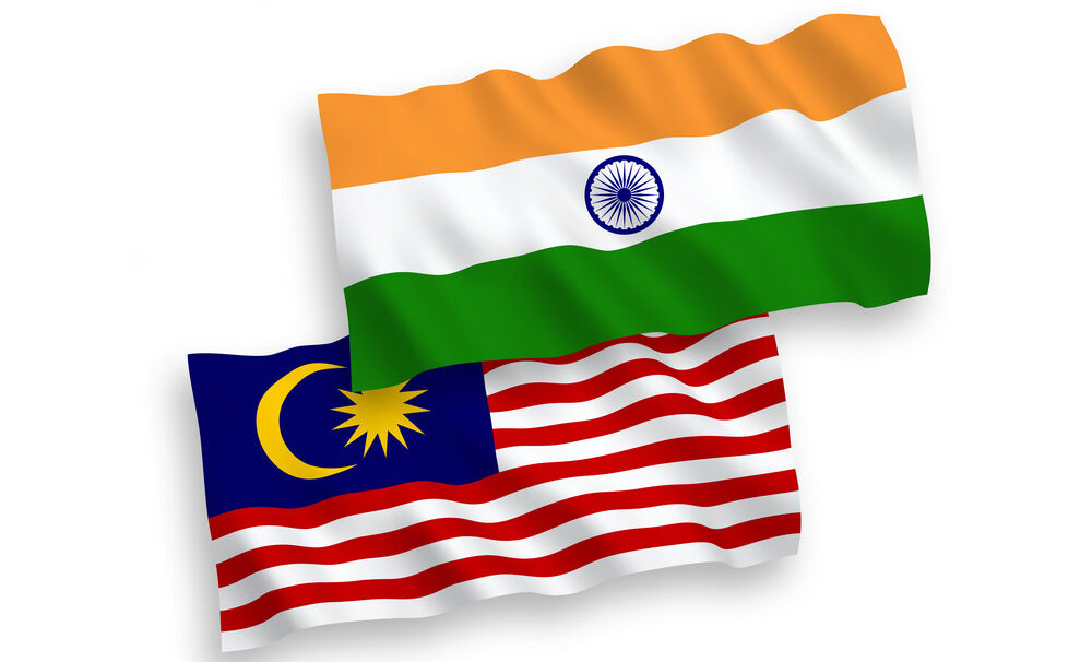 National vector fabric wave flags of India and Malaysia isolated on white background. 1 to 2 proportion.