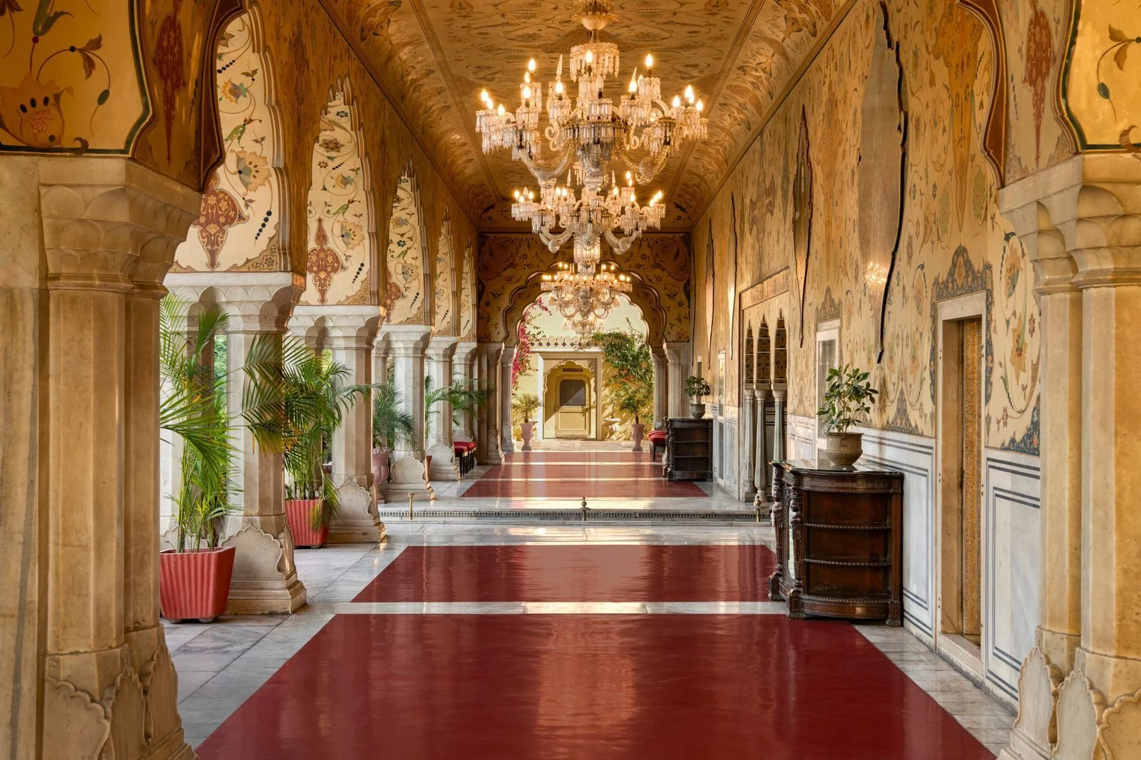 Image may contain Plant Indoors Floor Chandelier Lamp Architecture Building Corridor and Interior Design