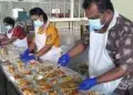 Volunteers preparing the packed meals at the temple.