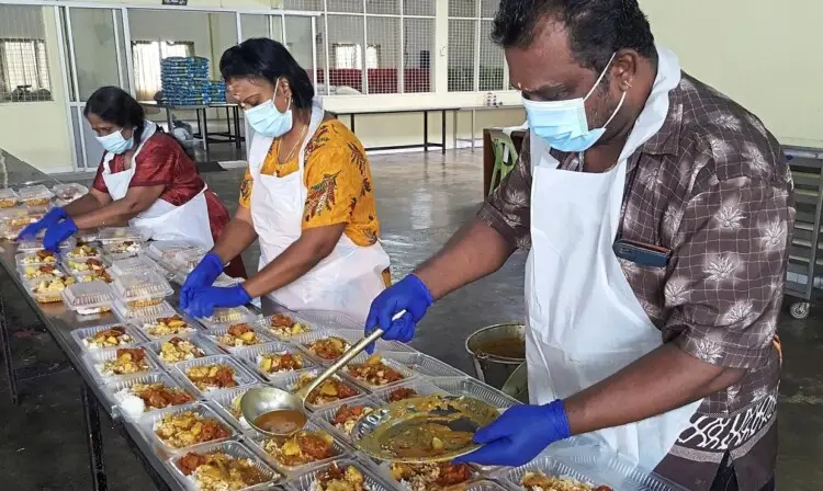Volunteers preparing the packed meals at the temple.